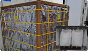 A large container wrapped in reflective foil and secured with yellow straps stands in a warehouse; an inset shows two white bags on a pallet, covered with clear plastic.