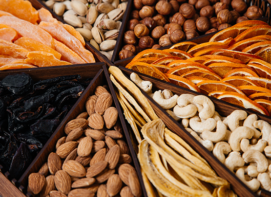 top-view-desk-with-nuts-walnuts-hazelnuts-almonds-inside-shaped-desk-white-desk-nut-walnut-salted-snack